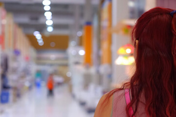 1 red-haired woman shopping in a shopping mall