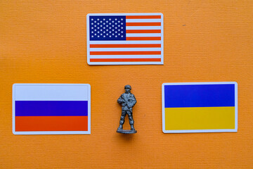 Flags of Russia, Ukraine and the USA on a yellow background. The Russian-Ukrainian conflict.