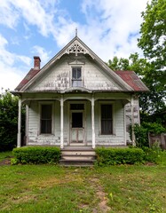 Weathered cottage under a partly cloudy sky
