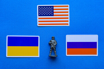 Flags of Russia, Ukraine and the USA on a blue background. The Russian-Ukrainian conflict.
