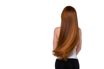 Naklejka premium Long, flowing red hair cascades down the back of a person standing against a plain background while wearing a simple top and black pants