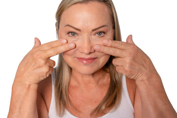 Fototapeta premium Woman demonstrates facial exercises for skin rejuvenation in a bright studio setting during daytime