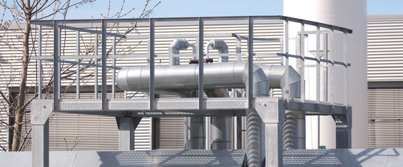 The photo shows close-up of pipeline elements at an industrial plant
