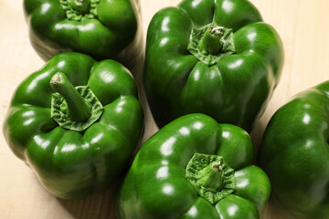 Green bell peppers on wooden background, closeup