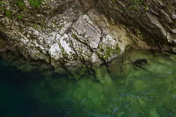 clean transparent canyon river with rocky bottom. rocky shore. rocky riverbed. abstract natural background with rock formations and mountain river