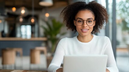 Focused woman smiling while using laptop modern cafe workspace, showcasing technology - Powered by Adobe