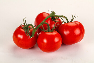 Ripe fresh tomato on the branch