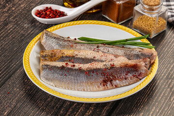 Salted marinated herring fillet with spices