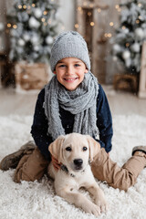 young boy and his playful puppy are filled with wonder as they admire magical winter landscape