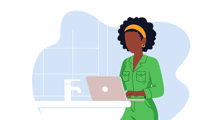 Black woman in a green jumpsuit working on a laptop in a modern, tiled setting. Represents remote work, productivity, and digital lifestyle.