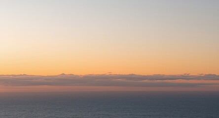 Fototapeta premium Ocean and Sky at Dawn. Serene Seascape with Warm Hues and Coastal Atmosphere.