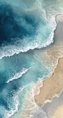 Fototapeta premium Aerial view of ocean waves crashing on a sandy beach. Softly colored turquoise and teal waves meet light beige sand