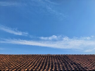 Clay roof tiles with clear blue sky with clouds for International clean air day for blue sky concept, Copy space