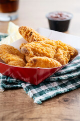 Crispy fried chicken tenders on wooden table