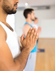 Fototapeta premium Men in yoga class, hands in prayer position
