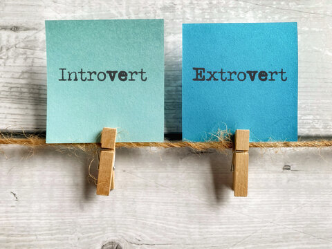 Personality concept - Introvert extrovert text on notepaper background. Stock photo.