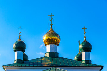 Green and white church cathedral with golden dome Mir Belarus.