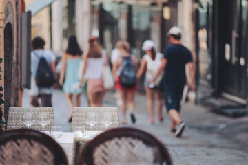Charming street in a historic town filled with summer wanderers enjoying leisurely moments and discovering hidden gems during a sunny afternoon