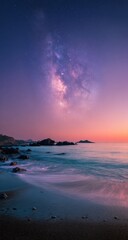Fototapeta premium Blurry seascape at twilight, milky way streaks across a vibrant sunset sky