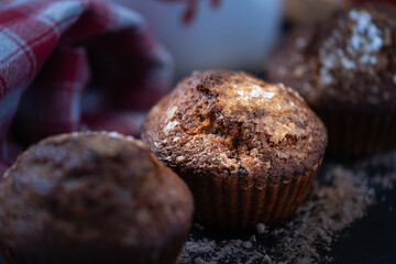 Close-up of homemade muffins with crunchy topping, warm background, rustic baked goods concept.