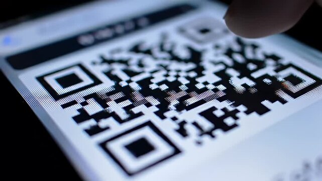 Macro shot of a dynamic QR code displayed on a bright screen, angled perspective