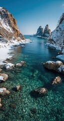 Coastal winter scene, clear turquoise water, snowy rocks