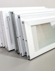White window frames stacked indoors