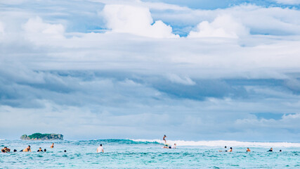 Family surfing in Cloud 9 beach, Siargao Island, Philippines