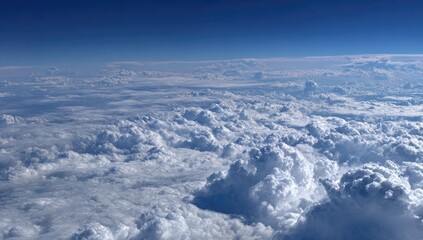 High-altitude view of fluffy cumulus clouds against a vibrant blue sky