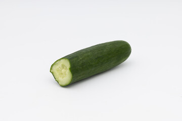 Green cucumber, cut, on white.