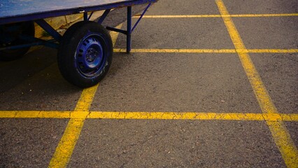 rustic transportation cart on painted asphalt