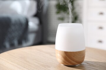 One stylish aroma lamp on wooden table indoors, closeup. Space for text