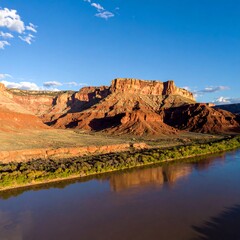 Red rock canyon reflecting on a river