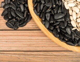 Wooden bowl with black and white sunflower seeds.  Yin and Yang
