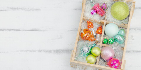 Trendy Kitschmas background. Vintage New Year balls, pink fir tree branches, silver garland