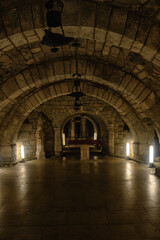 Fototapeta premium Underground stone crypt with arches in San Antolin Cathedral, Palencia