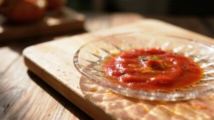 Delicious homemade tomato sauce in glass bowl on rustic wooden board, perfect for food blogs or restaurant menus, capturing the essence of fresh, authentic Italian cuisine