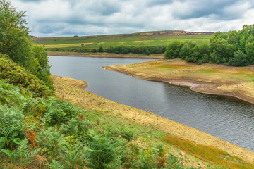 Fototapeta premium Leighton Reservoir in Nidderdale, North Yorkshire in August 2025 when water levels were exceptionally low and a hosepipe ban introduced. Horizontal. Copy Space