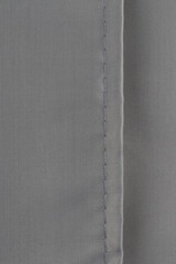 Fototapeta premium a neat seam on the gray polyester material