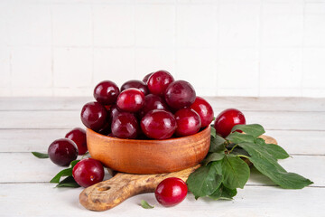 Fresh raw ripe cherry plum with leaves