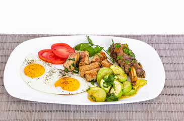 Roasted meat with sunny-side eggs, vegetables and salad. Healthy food, keto diet, diet lunch concept