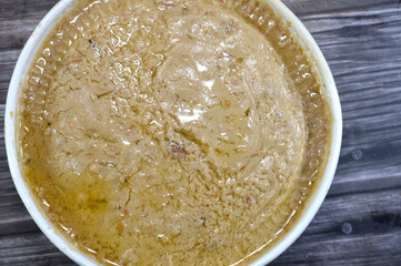 Egyptian fava beans with minced pickled safflower lemons, the main dish in the breakfast in Egypt, cooked with crushed bean, yellow lentils and wheat, Fava beans main dish of Suhor in Ramadan