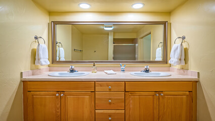 Traditional bathroom with double sink vanity and large mirror 
