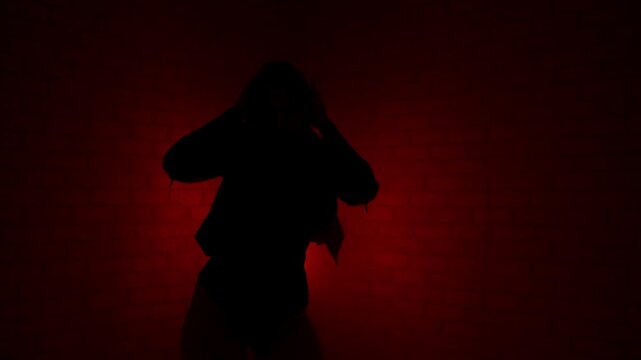 Slow motion silhouette of a sensual woman dancing in red neon fog, wearing heels and leather jacket, expressing erotic confidence and rhythm