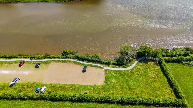 An aerial view panning up towards the Castle ruins at Carew, South Wales in summertime