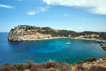 View of Anthony Quinn Bay with beaches and a ship on the island of Rhodes