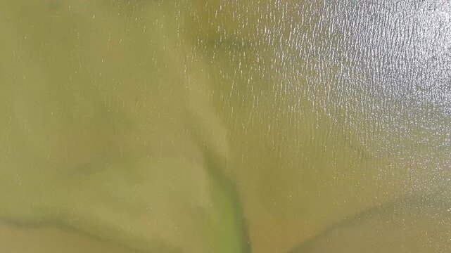 An aerial view panning up and rotating around the Castle ruins at Carew, South Wales in summertime