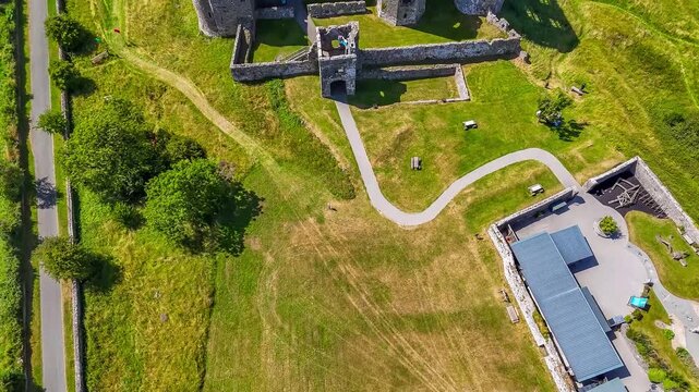 An aerial view flying over the Castle ruins at Carew, South Wales in summertime