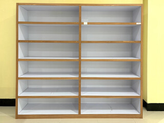 An empty wooden-framed shelving unit with multiple horizontal shelves, set against a plain white background
