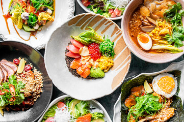 Assorted Asian fusion dishes including poke bowl, ramen, and rice plates with fresh vegetables, seafood, egg, and vibrant garnishes, served in ceramic bowls.